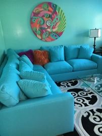 Crate and Barrel Aqua sleeper sectional - no fanny prints as it has never been used!  Custom fabric is called "Sun Brella" - it is very rugged outdoor material - yet still soft and comfortable!