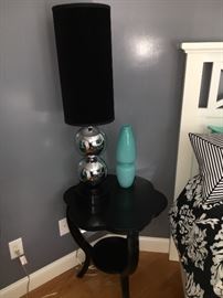Fun ebonized side table with chrome lamp with black fabric shade.