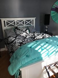 Queen sized panel bed with captivating geometrically patterned headboard. Great Mattress! Great Linens!