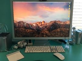 Mac Mini with Apple Cinema 30" monitor, keyboard and wireless mouse.