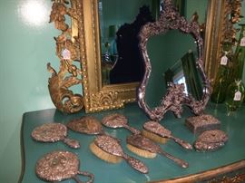Check out that stunning sterling silver vanity mirror in front of the large gold gilt mirror!