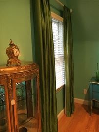 Several sets of heavy, luxurious, lined drapes - these here are in a striking brilliant emerald green.