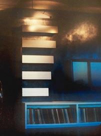 Amazing media shelving crafted in the spirit of Donald Judd "Stack" at MOMA NYC. These shelves are hung on the wall like a painting and make quite the statement. The next photo shows the original art at MOMA. 