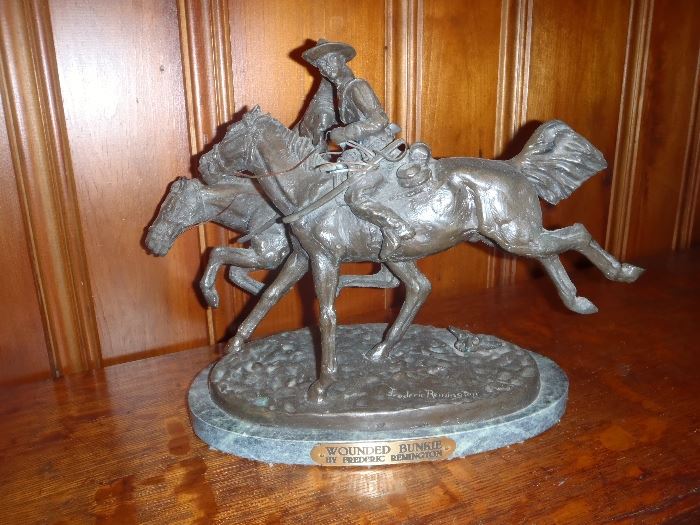 Wounded Bunkie.  By Frederic Remington.  Signed at base. 