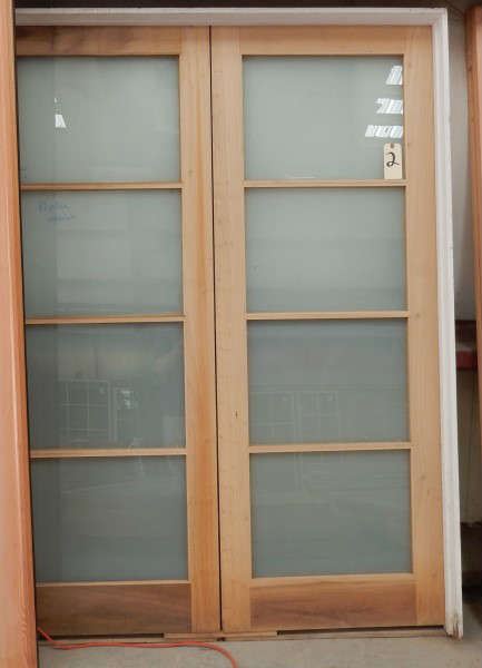 Pair of custom doors in frame with milk glass lights