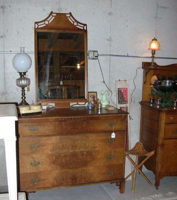 Dresser with mirror and Oriental lines. Antique oil lamp.