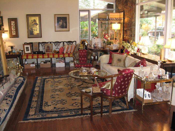 Front living room with large Oriental style carpet, brass and glass coffee table , brass and glass cart