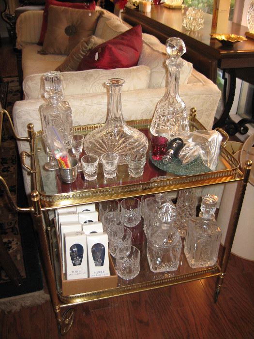 Heavy brass and glass bar cart, crystal and glass decanters. 