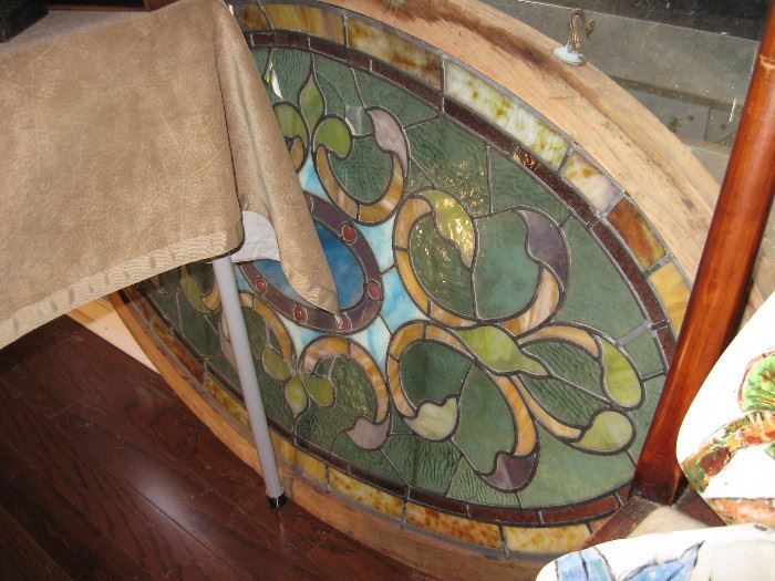 Large oval stained glass. Some missing or broken pieces 