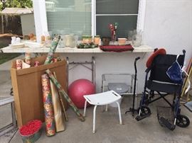 Lots of xmas wrapping; vases, cane, walker, collapsible transport chair, shower chair.