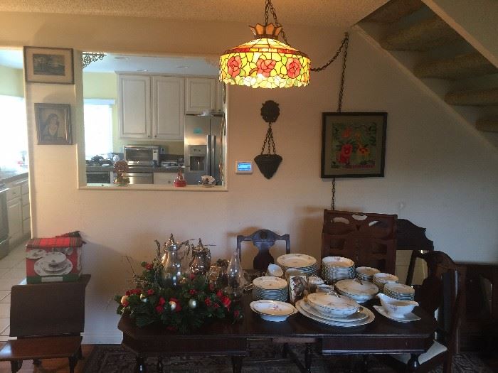 Tiffany style hanging lamp.  Silver Tea Service w/tray. Older Czech Fine China Set. Dark Wood Dining Room Table with built in leaf w/4 matching chairs. Medicine cabinet. Wooden child's school desk.