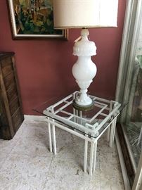 One of the pair of carved alabaster lamps on an attractive vintage iron side table with glass top