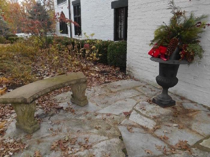 Entrance:  One of two concrete benches (priced separately) is next to one of a pair of 33" tall cast iron urns (priced as a pair). 