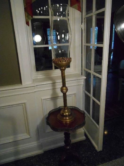 Dining Room:  A brass candlestick with glass hurricane shade.  Perfect for an altar!  It rests on a small mahogany stand.  