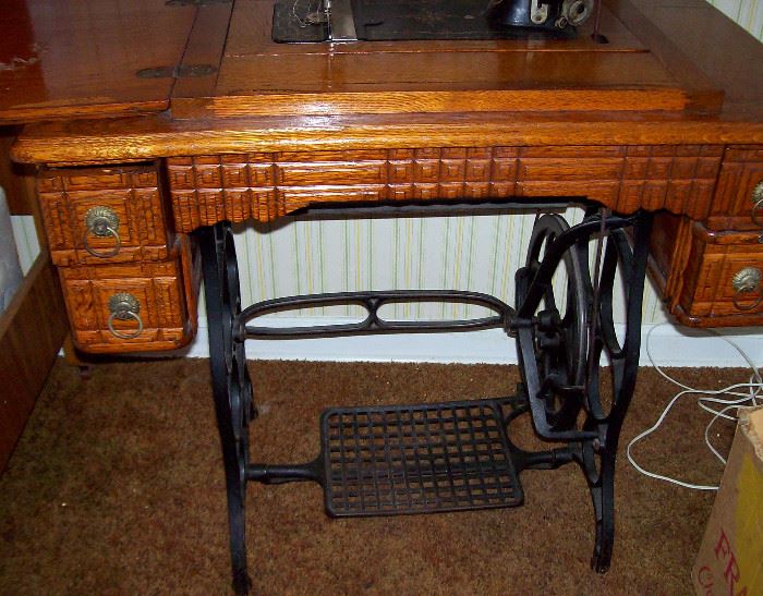 Treadle sewing machine in oak cabinet