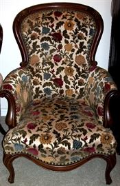 Wood trim arm chair has floral print upholstery