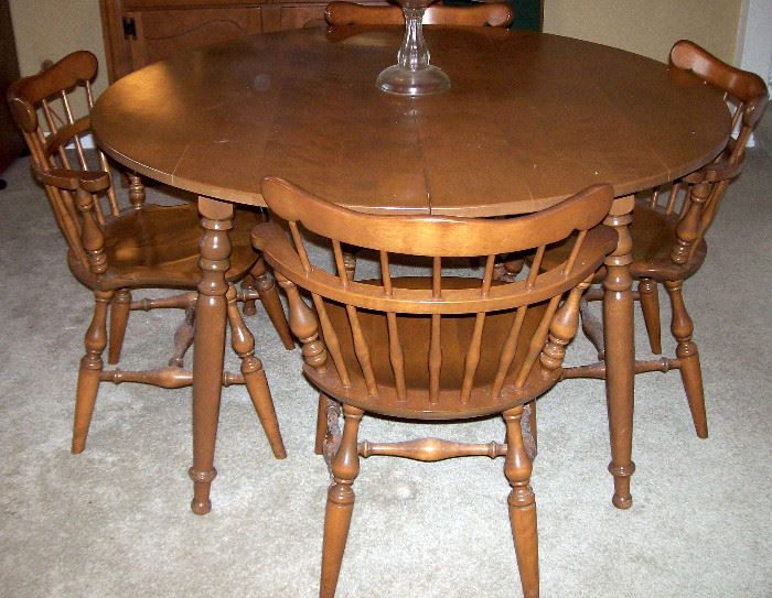 Round maple table has two leaves & four chairs