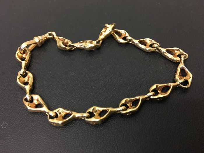 Gold Bracelet-14k yellow gold, fashion bracelet designed with (14) modified, oval shape open links accented with a classic style watch fob clasp.  Description and appraisal by:  Peter Naughter, G.G., A.G.S., Gemological Laboratory Oct 2016.  Fair market value is $440.00