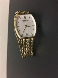 Lady's Stuhrling Wristwatch-gold plated (base metal), lady's fashion wristwatch designed in a cushion shape featuring a swiss quartz movement and a mother of pearl dial.  Description and appraisal by:  Peter Naughter G.G., A.G.S., Gemological Laboratory Oct 2016.  Fair market value $60.00