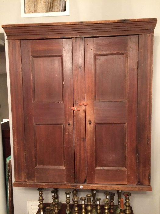 Primitive wall cupboard with shelves