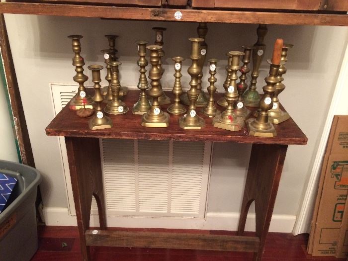 Antique brass candle sticks on a small primitive table