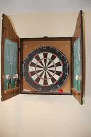 Dartboard cabinet includes darts and dartboard