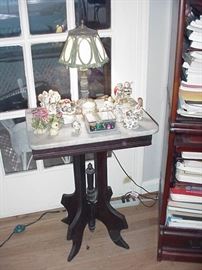 Marble top Victorian table; slag glass lamp; collectibles