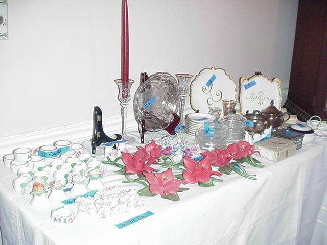 Lots of table top items including Capodimonte flowers, porcelain salts and peppers, place card holders, napkin rings, silver overlay, silverplate, and much more