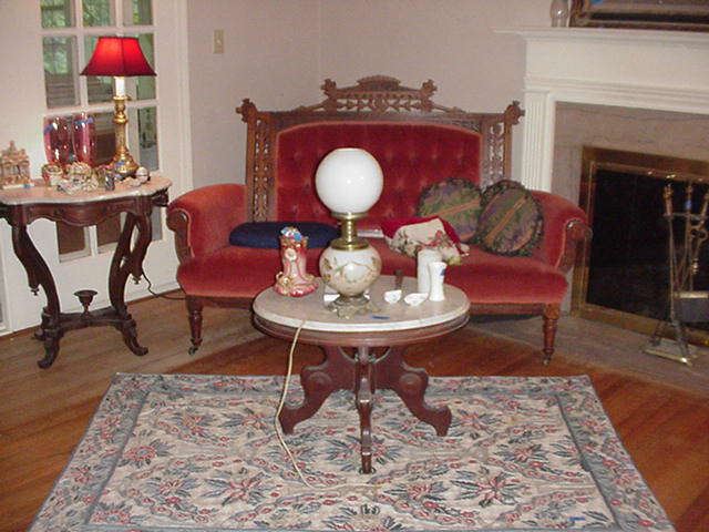 Needlepoint rug; two marble-top tables; Victorian sofa