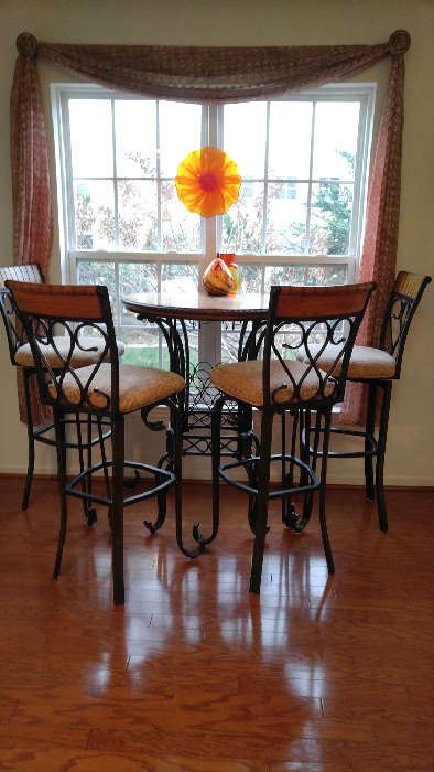 Bistro table with four swivel seat stools; wrought iron and oak