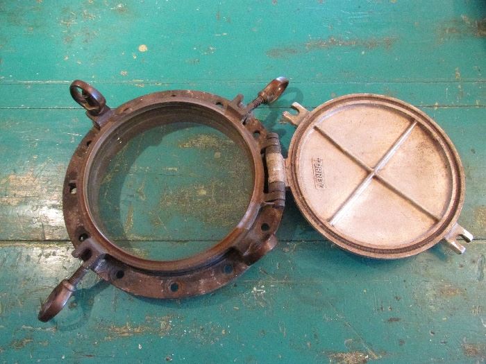 Large ship porthole with storm cover
