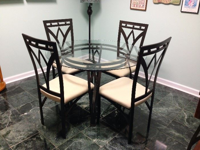 Black Metal Base Round Glass Top Dinette Table and Four Black Metal Upholstered Seat Dining Side Chairs