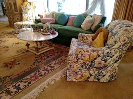 Living room with green velvet sofa, marble top coffee table, Chinese room rug