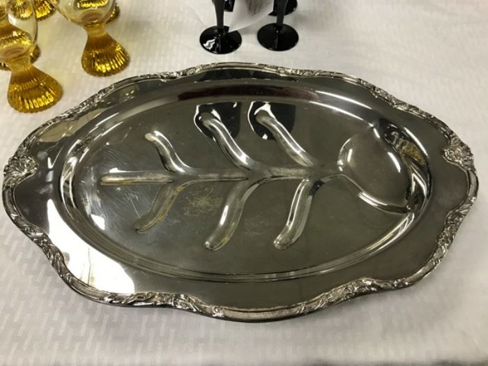 Footed silver plate meat platter measuring 18" long.