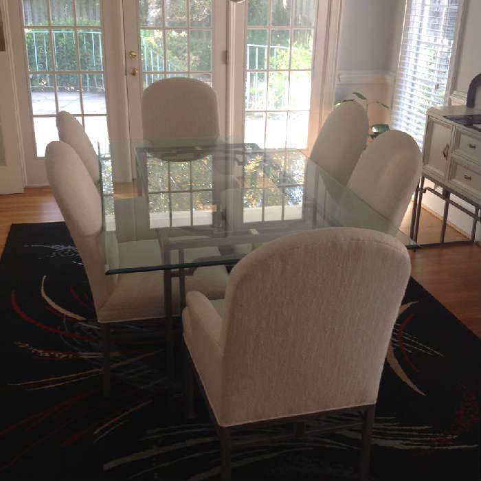 Beveled Glass top dining table with ornate metal base and 6 chairs (2 captains).  Table - 44" wide x 72" long x 29" tall.  Chairs 40" to top of back and 20" to seat bottoms.  Very minor wear / small stains on 2 of the chairs.  $ 400.00