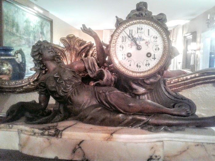 What a magnificent bronze mantle clock of woman housed on a solid marble base. Clock has Key!