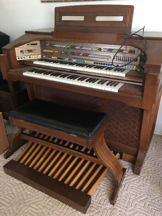 Lowrey organ with seat.  Music books.  Working condition.  Has been covered for 20 years!  Excellent condition.