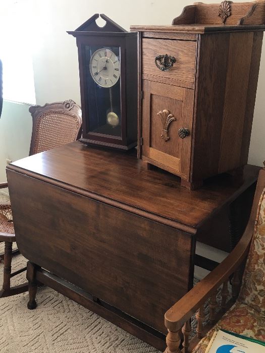Antique gate leg table with two extensions.  Small oak nightstand/side table.  Chiming clock with pendulum.  Cane rocking chair.