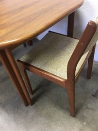 Danish teak dining table with two side chairs.  Very good condition.  Lovely mid century modern set.