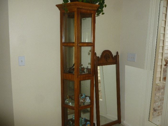 Curio cabinet and wood frame mirror.