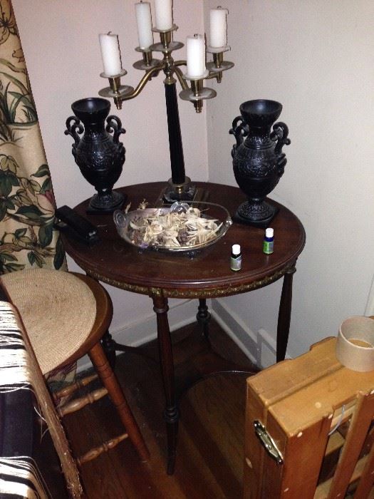 Occasional mahogany table with brass highlighted candleholder