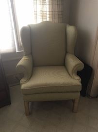 Sage green upholstered wingback chair