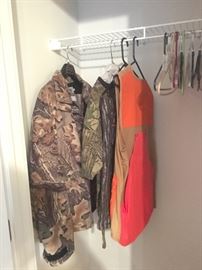 Assorted camo jackets, pants, and vests