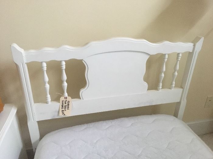 Detail of the white-washed twin-sized bed headboard