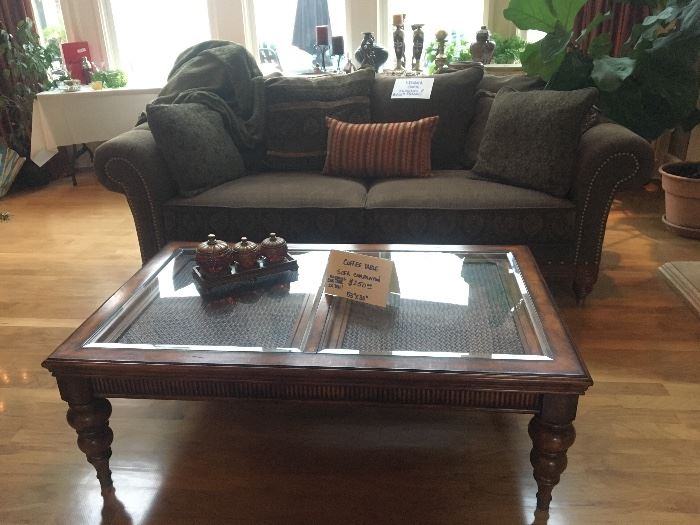 Olive green upholstered sofa, solid wood with glass accent coffee table (matching end table previously photographed in study)