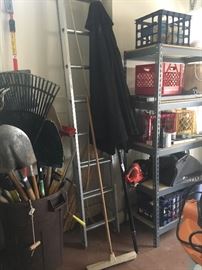 Handled yard tools, black umbrella, aluminum extension ladder
