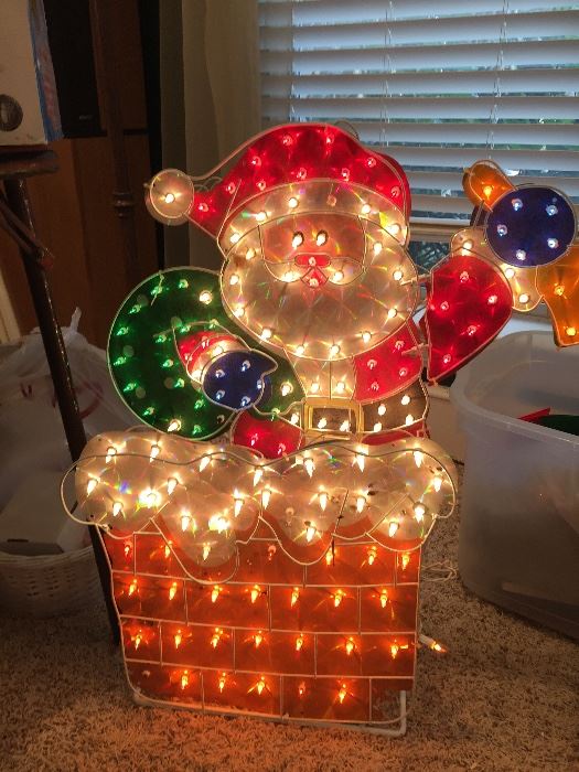 Santa is ready to come down  the chimney in this light-up decoration.