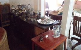 Vintage bar ware. Childs small table with two matching chairs.Old office desk chairs in background
