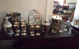 Asian style bar fold out top extends serving area. Silver plate hand hammered martini set. Pinguin chiller, bar ware, etc