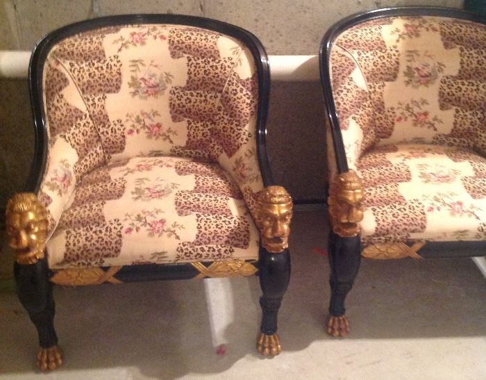 Pair of French Empire style ebonized and gilt chairs with lion heads